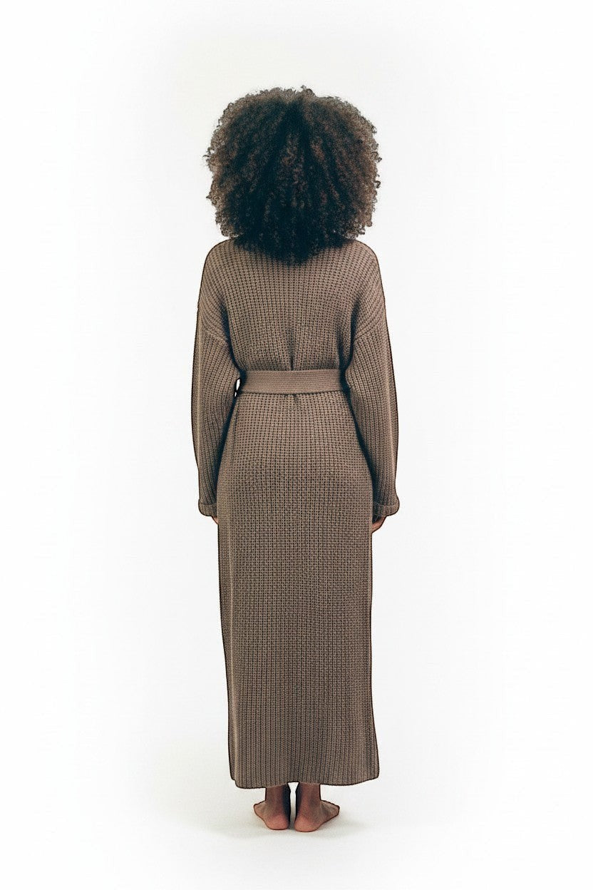 AMI CHÉRIE DESIGN STUDIO taupe longline knit robe with belt, deep V-neck, side pockets, and relaxed silhouette.